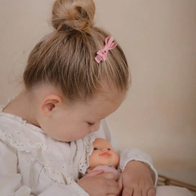 Meisje met een roze haarspeldje in het haar, geschikt voor peuters en kleuters